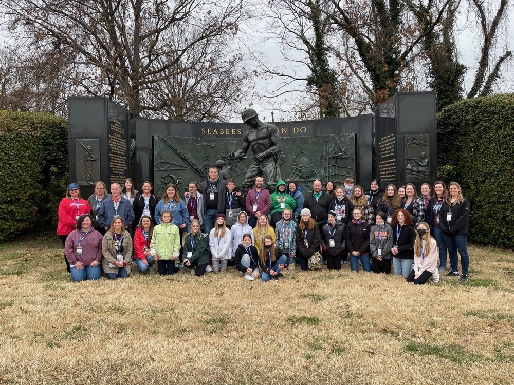 Members of Attica’s National Junior Society chapter pose for a photo in front of the Seabees Memorial near the entrance to Arlington National Cemetery during a service trip in December. 