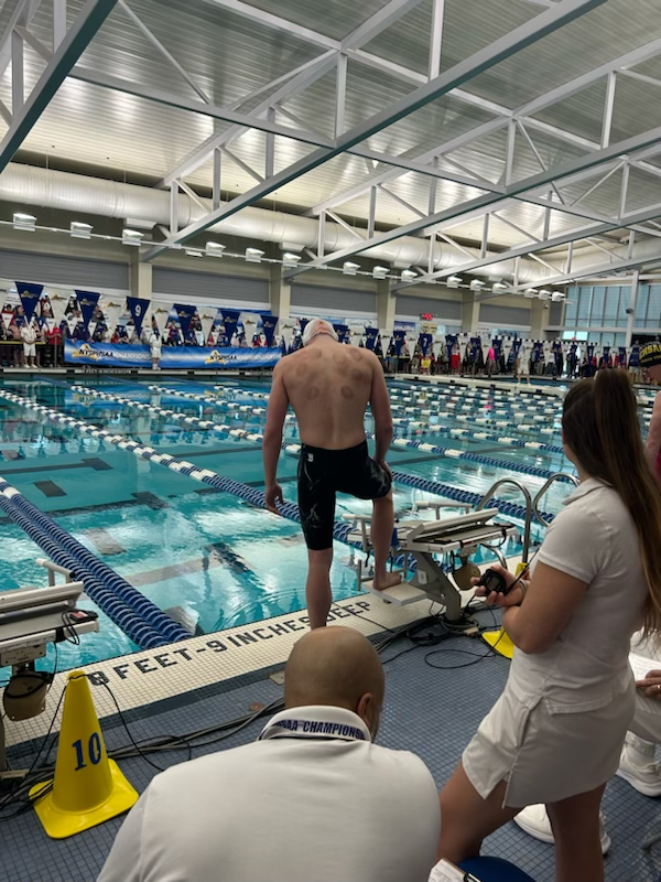 Joe Parkhurst competes in the 50-yard freestyle finals at the New York State Swimming and Diving Championships at Ithaca College. 