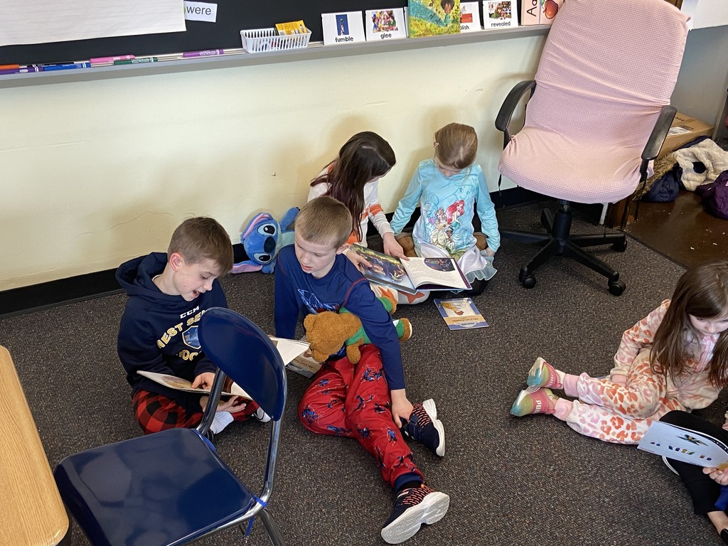 Miss Lauren Kocher’s third graders and Mrs. Dylah Fagan’s first graders are pictured reading together during Reading Week last week at Attica Elementary School. 