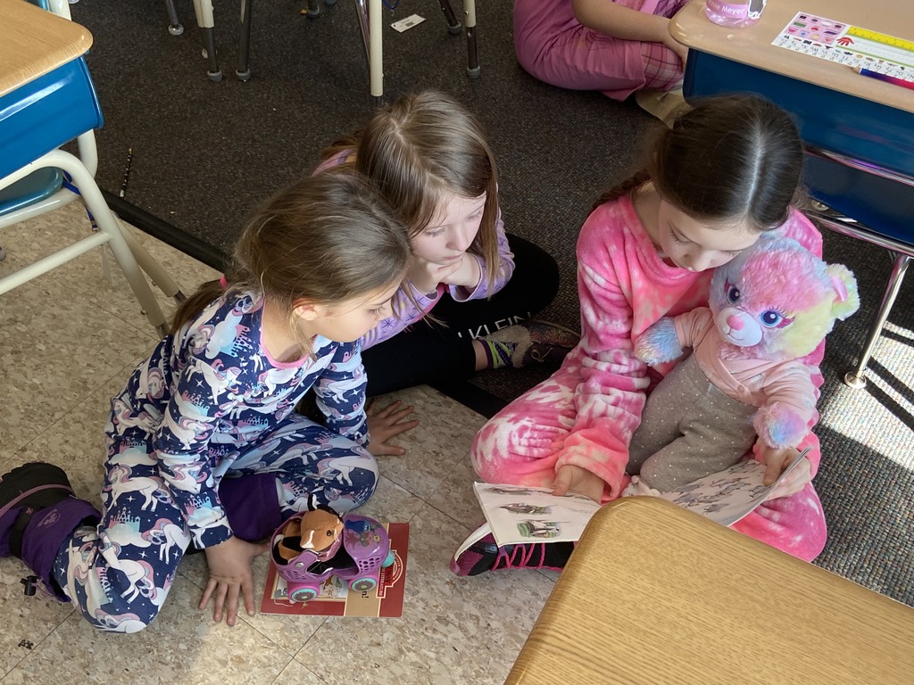 Miss Lauren Kocher’s third graders and Mrs. Dylah Fagan’s first graders are pictured reading together during Reading Week last week at Attica Elementary School. 