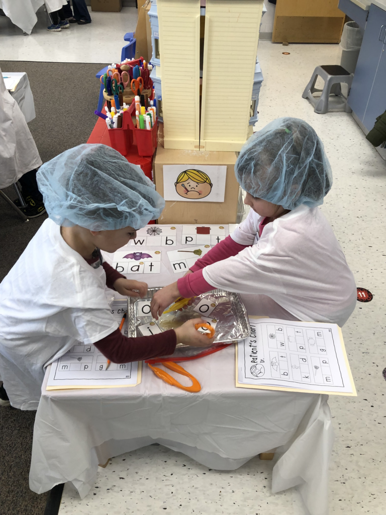 Students in Mrs. Kristin Janes’ kindergarten class are pictured performing “surgery” on ailing words during a recent reading lesson.