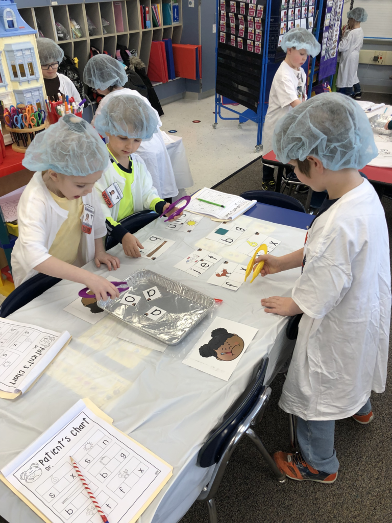 Students in Mrs. Kristin Janes’ kindergarten class are pictured performing “surgery” on ailing words during a recent reading lesson.