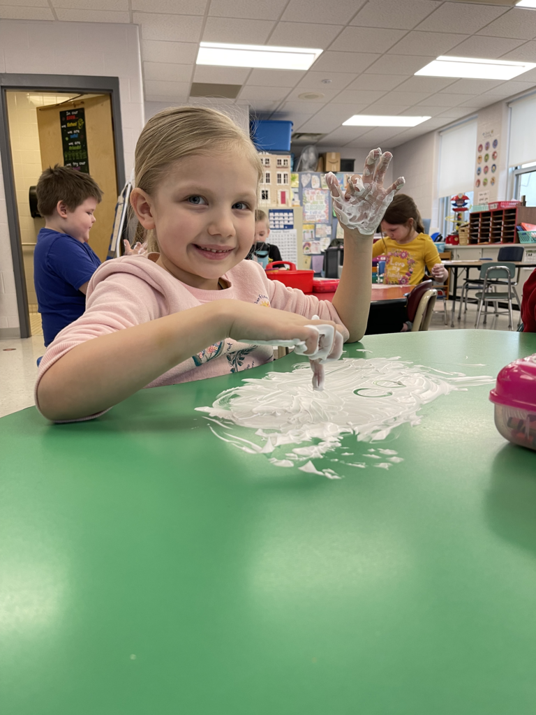 Mrs. Amanda Vilagy’s kindergarten students are pictured practicing their addition skills with shaving cream. 