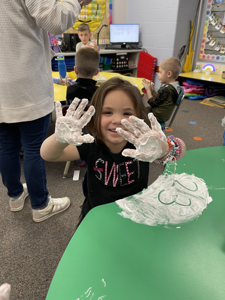 Mrs. Amanda Vilagy’s kindergarten students are pictured practicing their addition skills with shaving cream. 