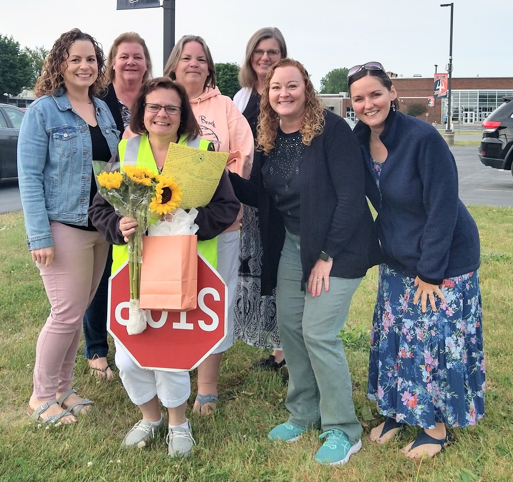 Tammy Baker poses for a photo with middle and high school staff members.
